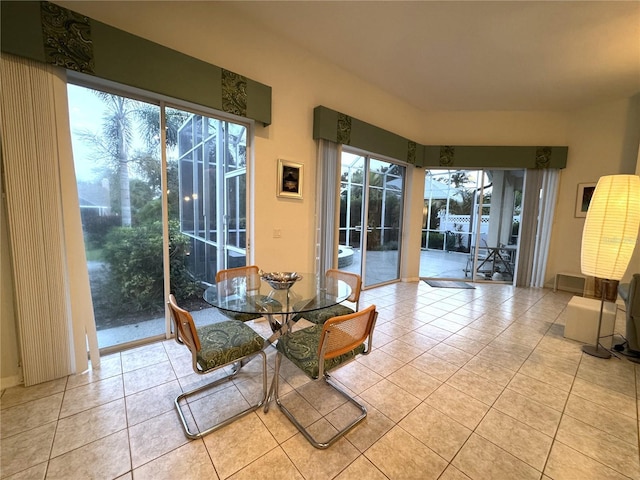8616 15th Ave NW, Bradenton, FL 34209 - dining area featuring a sunroom, plenty of natural light, and tile patterned floors