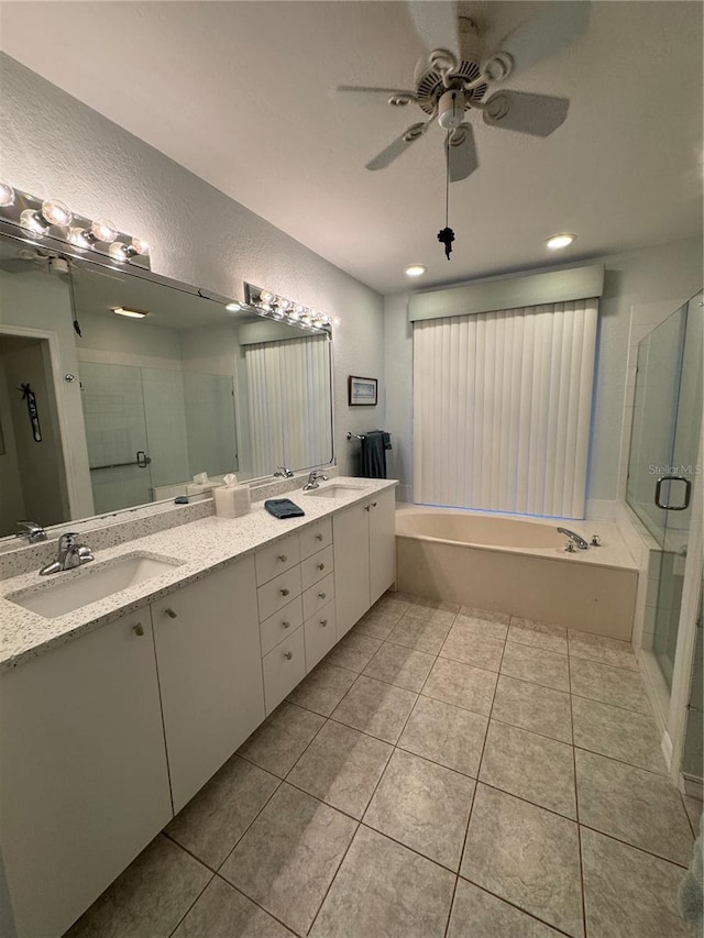 8616 15th Ave NW, Bradenton, FL 34209 - full bath featuring a bath, double vanity, a stall shower, ceiling fan, and tile patterned flooring