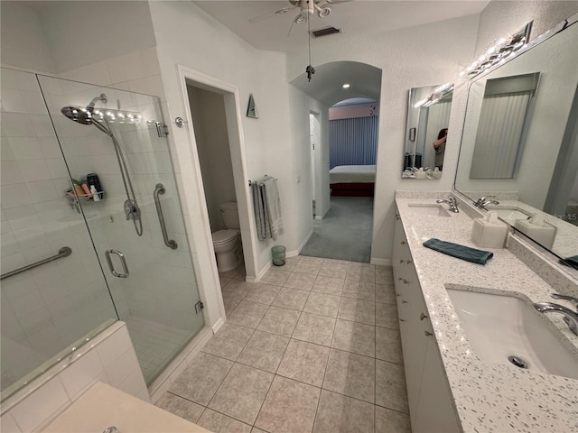8616 15th Ave NW, Bradenton, FL 34209 - bathroom featuring connected bathroom, double vanity, a shower stall, ceiling fan, and tile patterned flooring