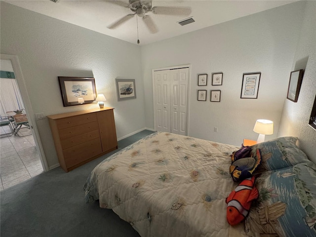 8616 15th Ave NW, Bradenton, FL 34209 - carpeted bedroom with a closet, ceiling fan, a textured wall, and tile patterned flooring