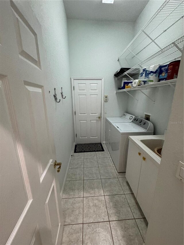8616 15th Ave NW, Bradenton, FL 34209 - laundry room featuring washer and dryer, cabinet space, and light tile patterned floors