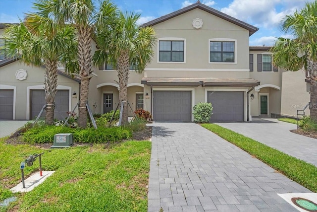 15131 Sunny Day Dr, Bradenton, FL 34211 - view of property with stucco siding, decorative driveway, and an attached garage