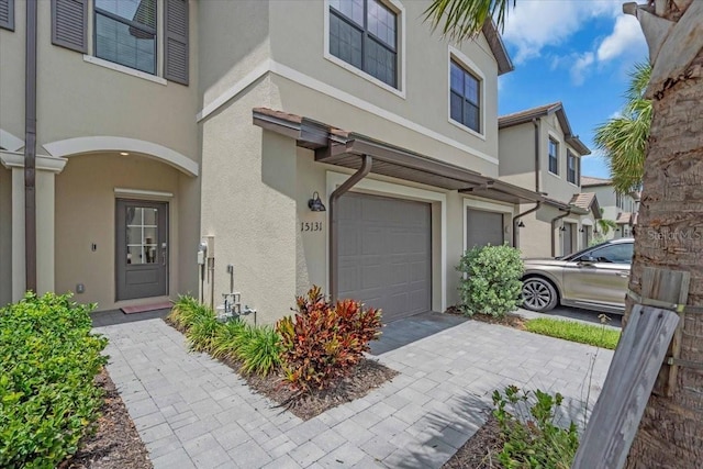 15131 Sunny Day Dr, Bradenton, FL 34211 - view of front of home featuring stucco siding, an attached garage, and driveway