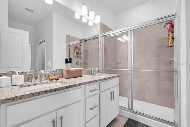 15131 Sunny Day Dr, Bradenton, FL 34211 - full bathroom featuring double vanity, a shower stall, and tile patterned flooring