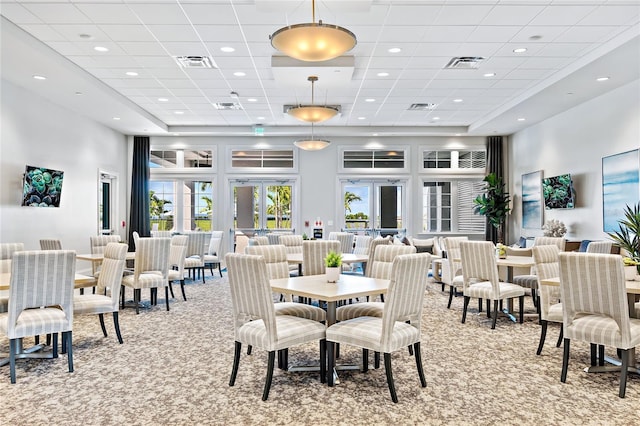 15131 Sunny Day Dr, Bradenton, FL 34211 - dining space featuring light carpet, a towering ceiling, a paneled ceiling, and recessed lighting
