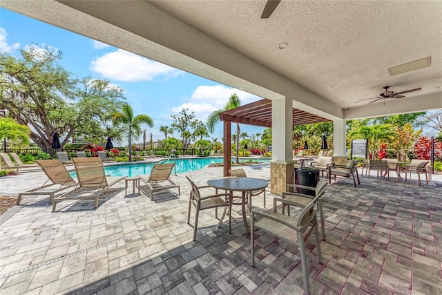 5711 Archipelago St, Nokomis, FL 34275 - view of patio with a ceiling fan, a pergola, and a community pool