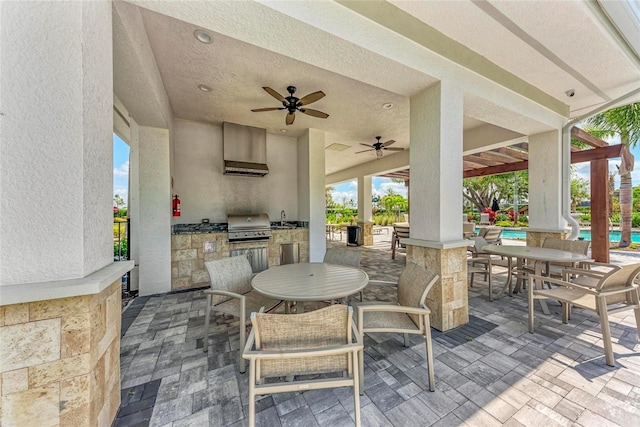 5711 Archipelago St, Nokomis, FL 34275 - view of patio / terrace featuring exterior kitchen, outdoor dining space, a ceiling fan, and an outdoor pool
