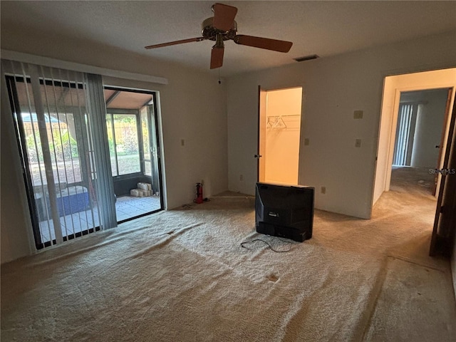 4199 66th Street Cir W Unit 4199, Bradenton, FL 34209 - unfurnished room with light colored carpet, a ceiling fan, and a wood stove