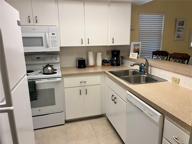 5310 Gulf Of Mexico Dr Unit 18, Longboat Key, FL 34228 - kitchen featuring white appliances, light tile patterned flooring, white cabinetry, and decorative backsplash