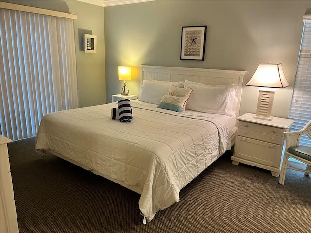 5310 Gulf Of Mexico Dr Unit 18, Longboat Key, FL 34228 - bedroom featuring dark colored carpet and ornamental molding