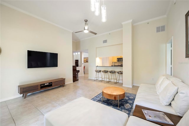 1064 N Tamiami Trl Unit 1125, Sarasota, FL 34236 - living area featuring light tile patterned floors, crown molding, a ceiling fan, and a towering ceiling