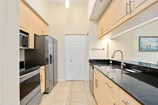 1064 N Tamiami Trl Unit 1125, Sarasota, FL 34236 - kitchen featuring stainless steel appliances, light tile patterned floors, and dark stone counters