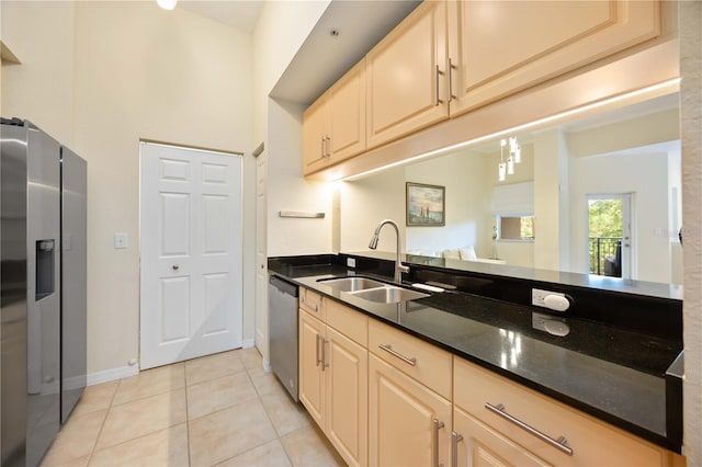 1064 N Tamiami Trl Unit 1125, Sarasota, FL 34236 - kitchen with appliances with stainless steel finishes, light tile patterned floors, dark stone countertops, cream cabinets, and a high ceiling