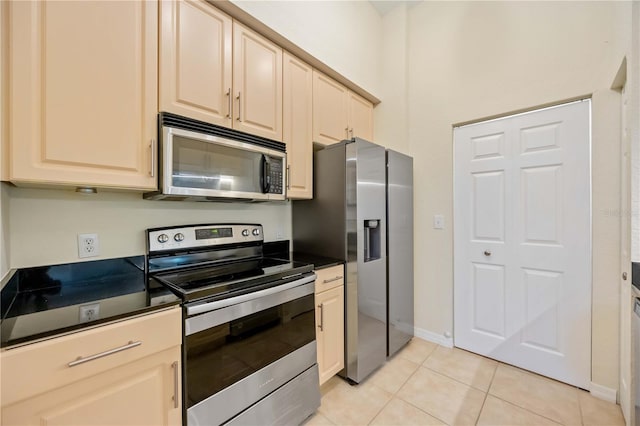 1064 N Tamiami Trl Unit 1125, Sarasota, FL 34236 - kitchen with stainless steel appliances, dark countertops, and light tile patterned flooring