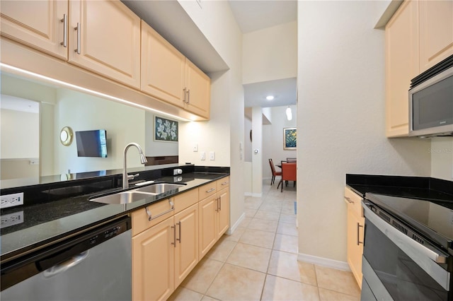 1064 N Tamiami Trl Unit 1125, Sarasota, FL 34236 - kitchen featuring appliances with stainless steel finishes and light tile patterned floors