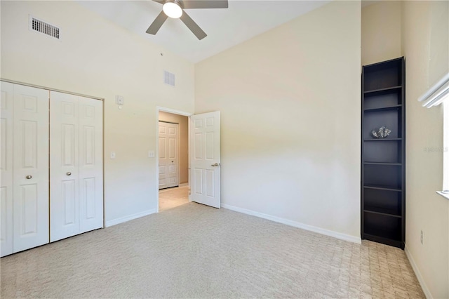 1064 N Tamiami Trl Unit 1125, Sarasota, FL 34236 - unfurnished bedroom featuring high vaulted ceiling, carpet, a closet, and ceiling fan