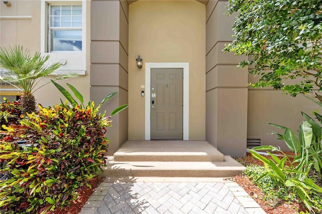 1064 N Tamiami Trl Unit 1125, Sarasota, FL 34236 - doorway to property featuring stucco siding