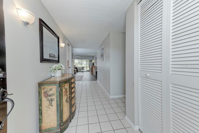 7110 Fairway Bend Ln Unit 181, Sarasota, FL 34243 - hallway with light tile patterned floors and a textured ceiling