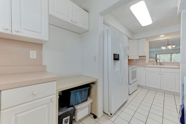 7110 Fairway Bend Ln Unit 181, Sarasota, FL 34243 - kitchen featuring white appliances, light tile patterned floors, white cabinetry, and a chandelier