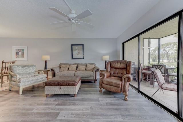 7110 Fairway Bend Ln Unit 181, Sarasota, FL 34243 - living area featuring light wood-style floors, a ceiling fan, and a textured ceiling