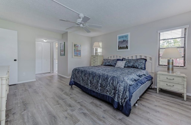 7110 Fairway Bend Ln Unit 181, Sarasota, FL 34243 - bedroom with wood finished floors, a textured ceiling, and a ceiling fan