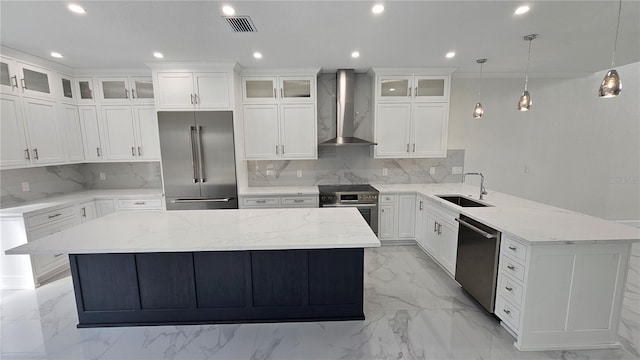 1240 Solitude Ln, Sarasota, FL 34242 - kitchen with wall chimney range hood, stainless steel appliances, a peninsula, recessed lighting, and tasteful backsplash