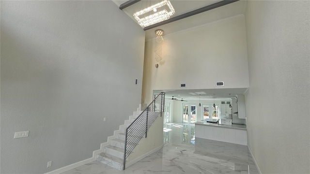 1240 Solitude Ln, Sarasota, FL 34242 - stairway featuring marble finish floors and a chandelier