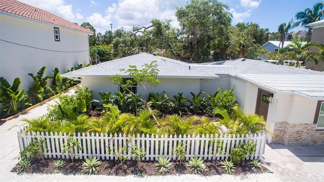 1240 Solitude Ln, Sarasota, FL 34242 - view of property exterior featuring stucco siding and a shingled roof
