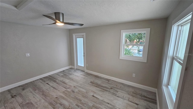 1240 Solitude Ln, Sarasota, FL 34242 - unfurnished room featuring wood finished floors, a textured ceiling, and ceiling fan
