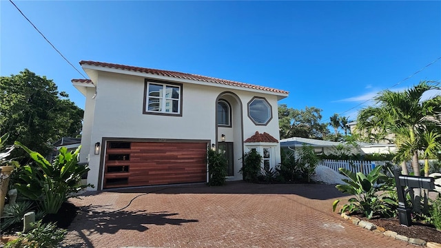 1240 Solitude Ln, Sarasota, FL 34242 - mediterranean / spanish-style house featuring an attached garage, stucco siding, and decorative driveway