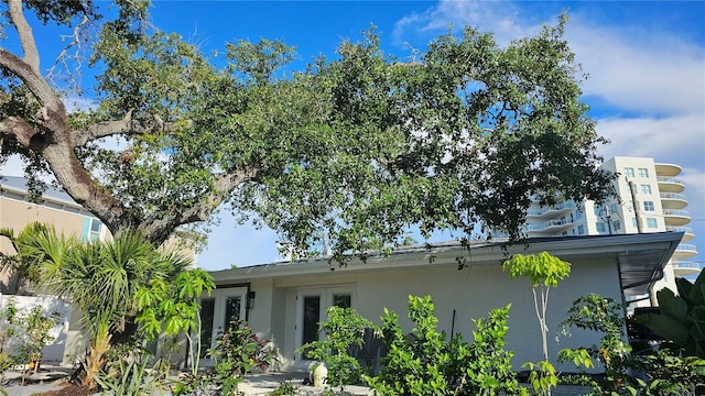 1240 Solitude Ln, Sarasota, FL 34242 - rear view of house with stucco siding and french doors