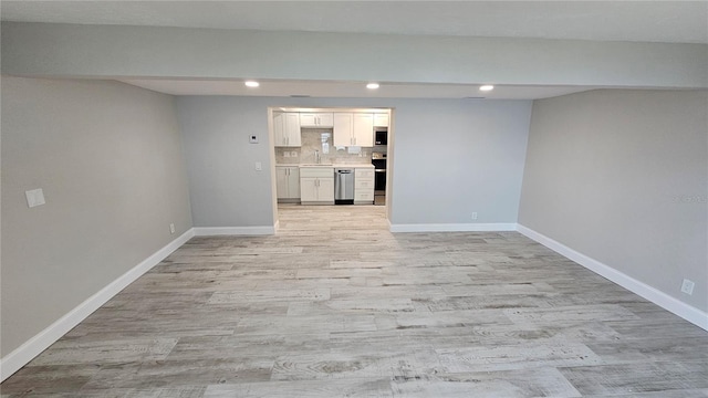 1240 Solitude Ln, Sarasota, FL 34242 - unfurnished living room featuring recessed lighting and light wood-type flooring