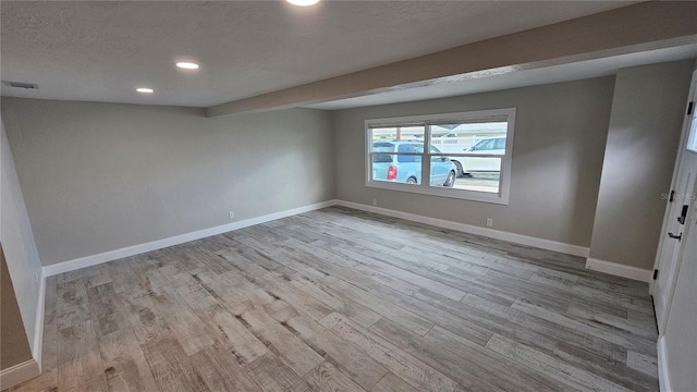 1240 Solitude Ln, Sarasota, FL 34242 - empty room featuring wood finished floors, recessed lighting, and a textured ceiling