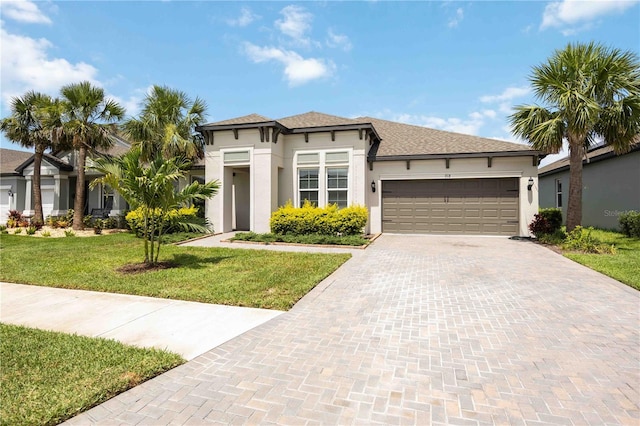 918 Fernleaf Run, Bradenton, FL 34212 - view of front of property with stucco siding, an attached garage, decorative driveway, and a front lawn