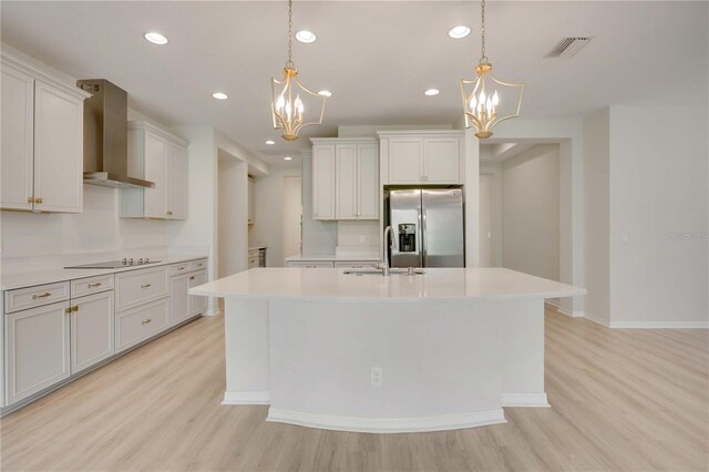 918 Fernleaf Run, Bradenton, FL 34212 - kitchen with wall chimney exhaust hood, stainless steel fridge with ice dispenser, a chandelier, light wood-style floors, and recessed lighting