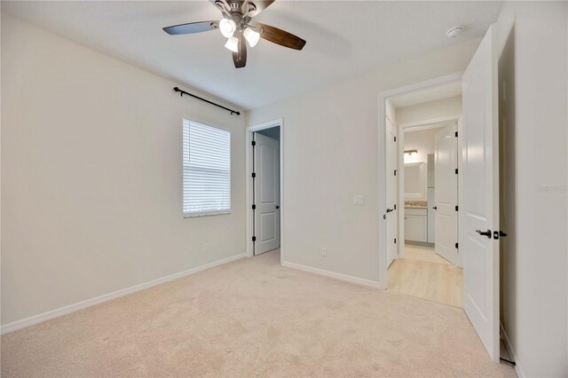 918 Fernleaf Run, Bradenton, FL 34212 - unfurnished bedroom featuring light colored carpet and ceiling fan