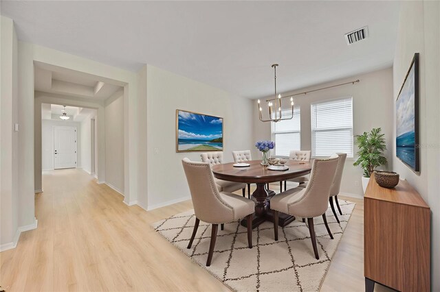 918 Fernleaf Run, Bradenton, FL 34212 - dining area with a chandelier and light wood-style floors