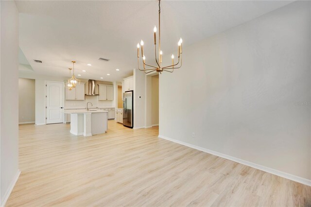 918 Fernleaf Run, Bradenton, FL 34212 - unfurnished living room with light wood finished floors, a chandelier, and recessed lighting