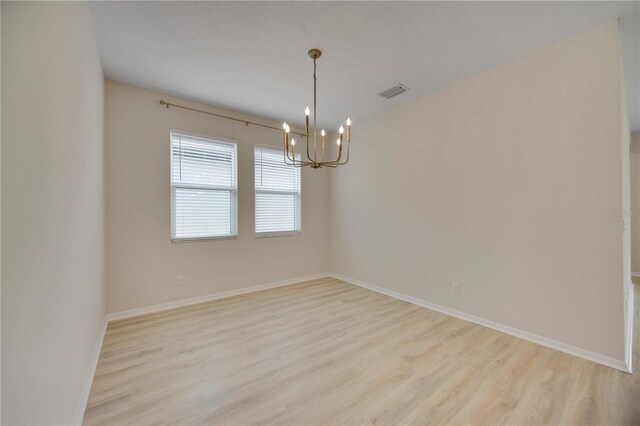 918 Fernleaf Run, Bradenton, FL 34212 - unfurnished room featuring a chandelier and light wood finished floors