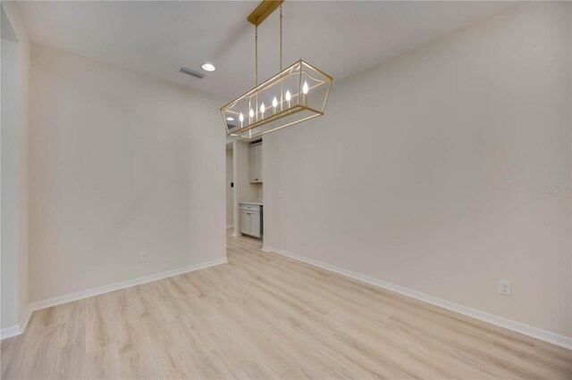 918 Fernleaf Run, Bradenton, FL 34212 - spare room with a chandelier, recessed lighting, and light wood-type flooring