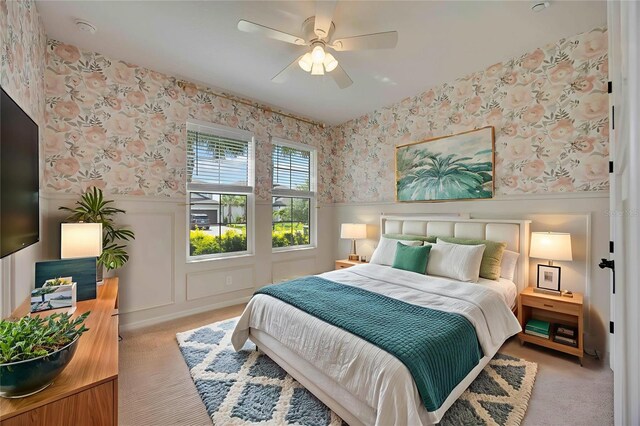 918 Fernleaf Run, Bradenton, FL 34212 - carpeted bedroom with wallpapered walls, wainscoting, and a ceiling fan