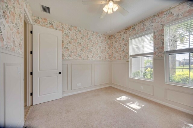918 Fernleaf Run, Bradenton, FL 34212 - unfurnished room with wallpapered walls, plenty of natural light, wainscoting, a decorative wall, and ceiling fan