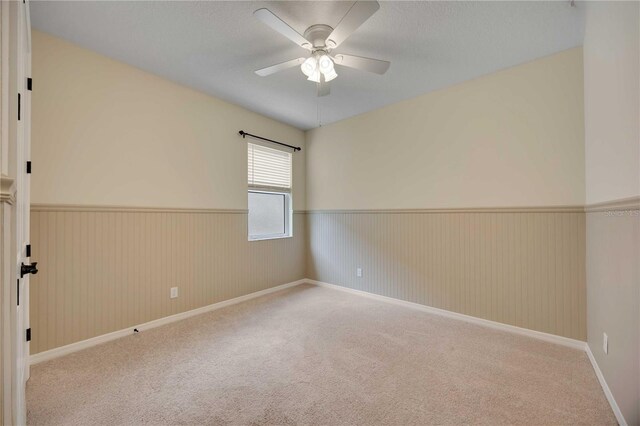 918 Fernleaf Run, Bradenton, FL 34212 - spare room with wainscoting, a ceiling fan, and carpet floors