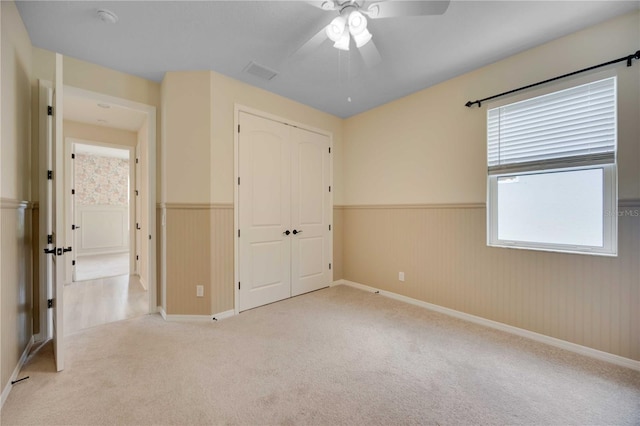 918 Fernleaf Run, Bradenton, FL 34212 - unfurnished bedroom featuring wainscoting, carpet floors, a closet, and a ceiling fan