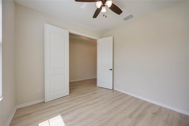 918 Fernleaf Run, Bradenton, FL 34212 - unfurnished bedroom featuring light wood-style floors and a ceiling fan
