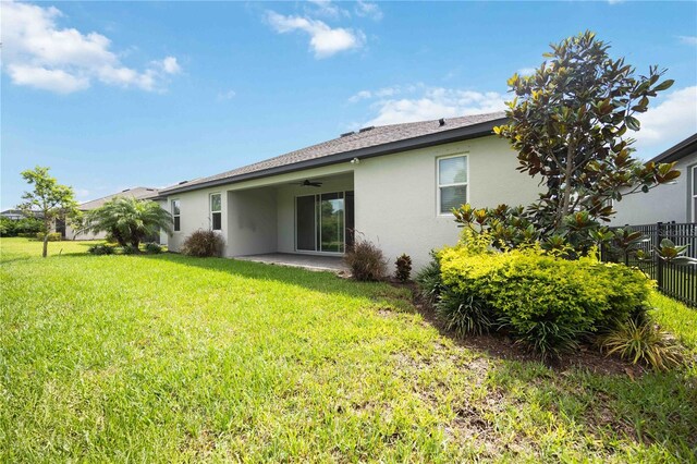 918 Fernleaf Run, Bradenton, FL 34212 - back of house with stucco siding, ceiling fan, and a patio