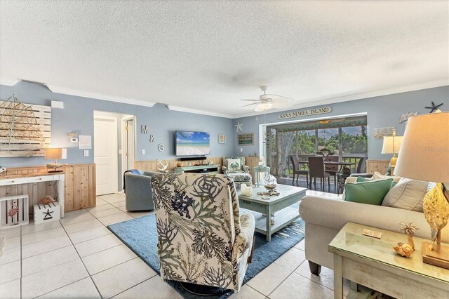 3810 75th St W Unit 128, Bradenton, FL 34209 - living room with a ceiling fan, light tile patterned floors, ornamental molding, a wainscoted wall, and a textured ceiling