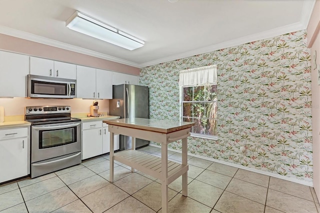 3810 75th St W Unit 128, Bradenton, FL 34209 - kitchen featuring stainless steel appliances, wallpapered walls, crown molding, white cabinets, and light countertops