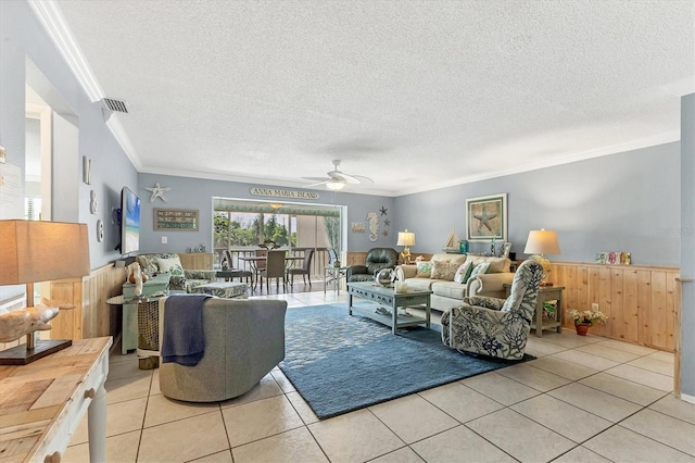 3810 75th St W Unit 128, Bradenton, FL 34209 - living room with ornamental molding, a ceiling fan, light tile patterned floors, a textured ceiling, and wainscoting