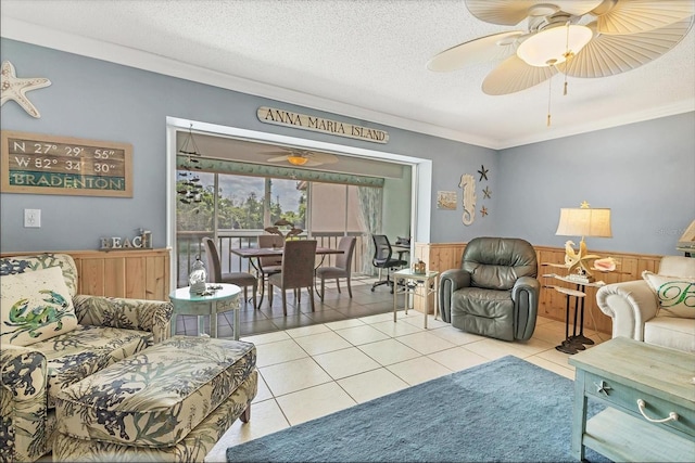 3810 75th St W Unit 128, Bradenton, FL 34209 - living area with ornamental molding, ceiling fan, a wainscoted wall, light tile patterned floors, and a textured ceiling